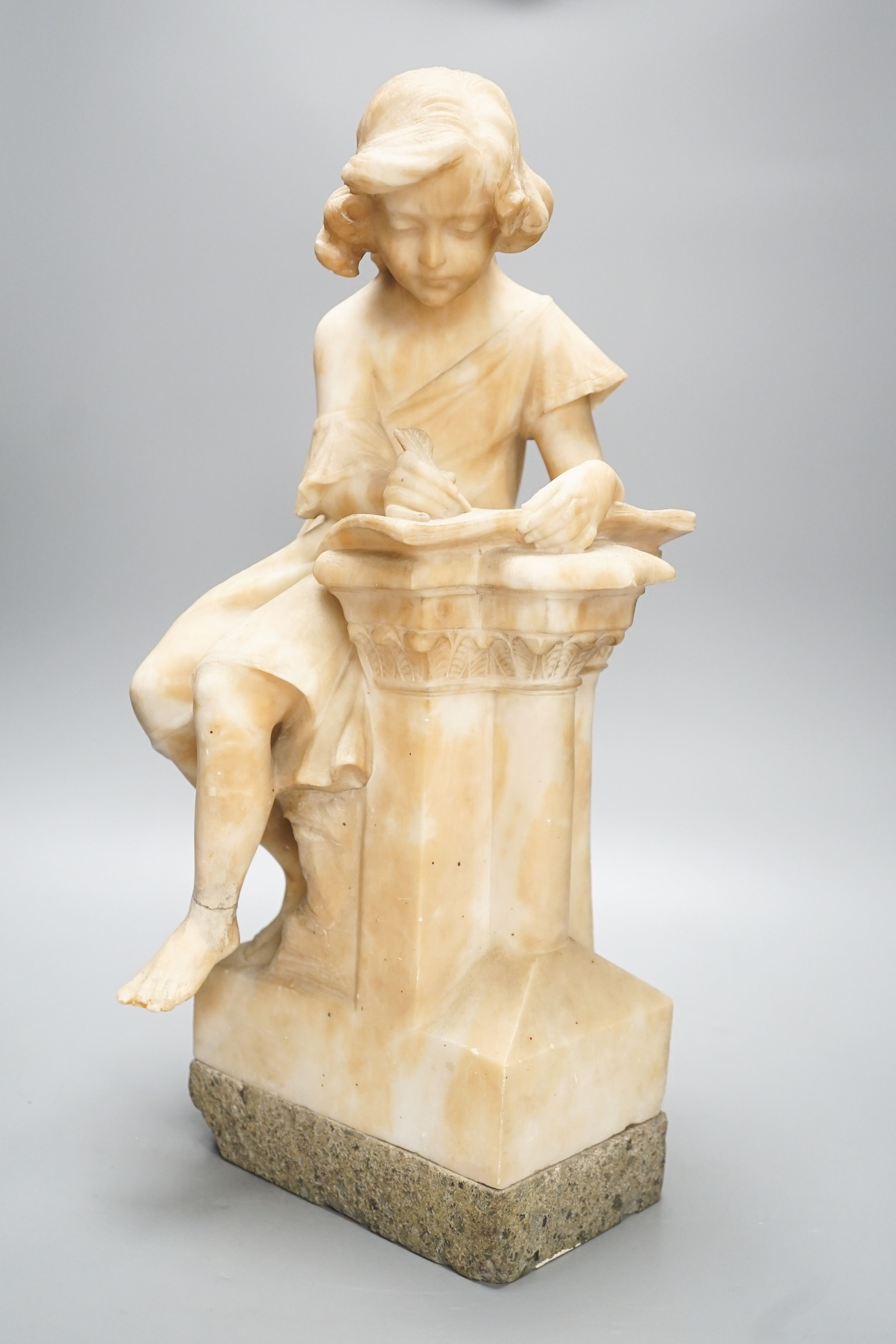 A late 19th century Italian carved alabaster figure of a girl seated, writing at a pillar 47cm